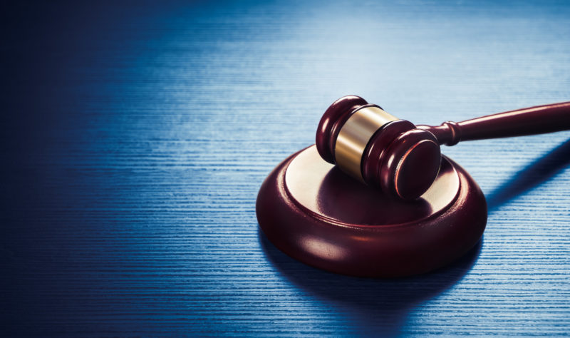 judge gavel on a blue wooden background Activist Legal Blog